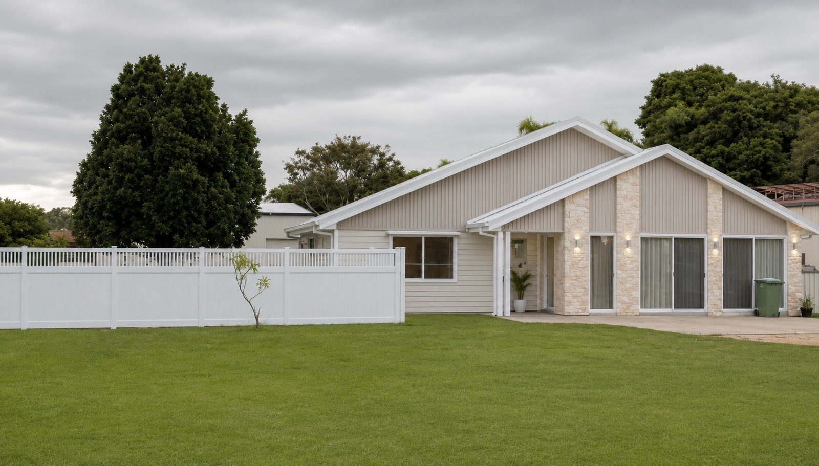Modern Queensland home with white semi privacy PVC fence along side boundary