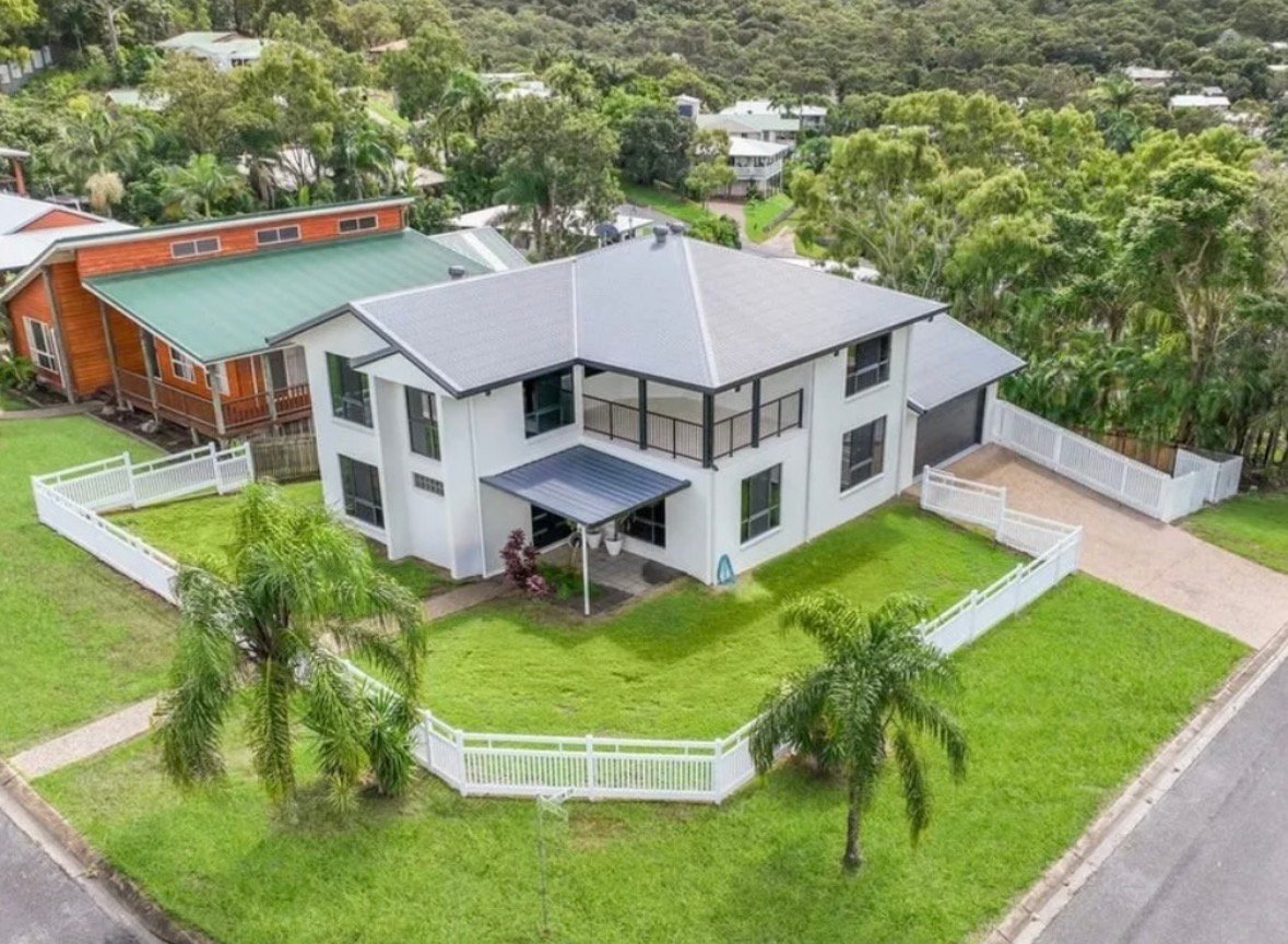 Aerial view of Queensland property fully enclosed with white PVC picket fencing
